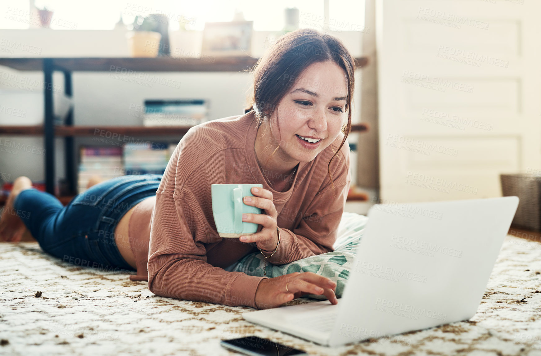 Buy stock photo Woman, laptop and smile on floor with communication, typing or social media scroll in home living room. Girl, lying and computer on carpet for chat, texting or technology with internet in lounge