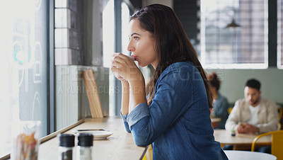 Buy stock photo Shot of an attractive young woman drinking coffee in a cafe