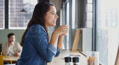 Buy stock photo Shot of an attractive young woman drinking coffee in a cafe