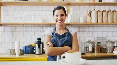 Buy stock photo Portrait of a young waitress standing behind a counter in a cafe