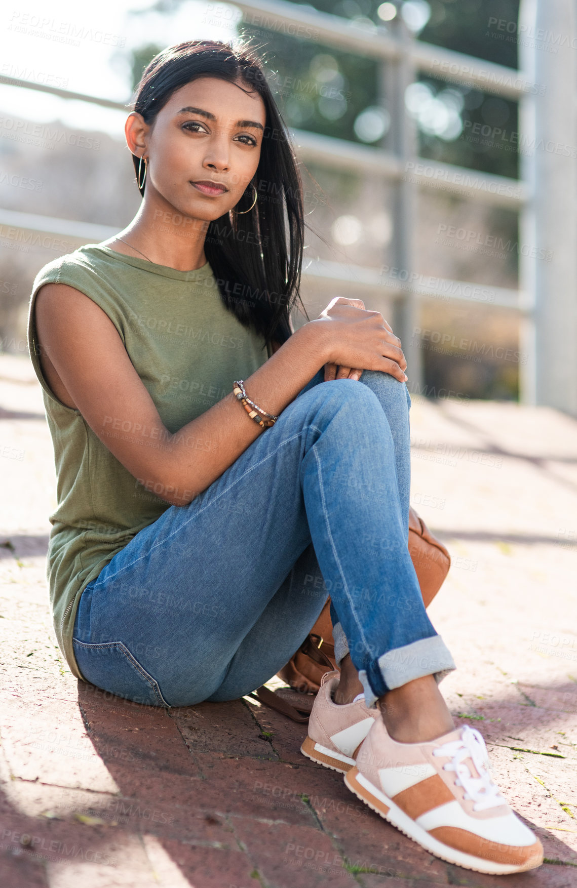 Buy stock photo Full length portrait of an attractive young woman looking serious while sitting in the city