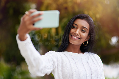 Buy stock photo Outdoor, smile and Indian woman in park, selfie and nature of sun, city and relax in weekend. Fashion, eco friendly and confidence for phone, happiness and bokeh in background, student and person