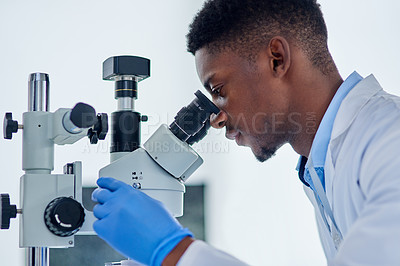 Buy stock photo Science, research and black man with microscope for analysis, investigation or medical engineering in laboratory. Biotech, lab technician or scientist checking vaccine sample for pharmaceutical test.