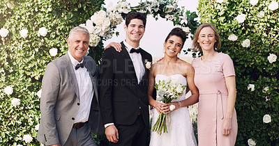 Buy stock photo Cropped portrait of an affectionate young newlywed couple standing with their parents on their wedding day