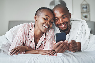 Buy stock photo Phone, contact and morning with a black couple in bed together to relax in the bedroom of their home. Mobile, meme or social media with a man and woman browsing the internet while relaxing or bonding