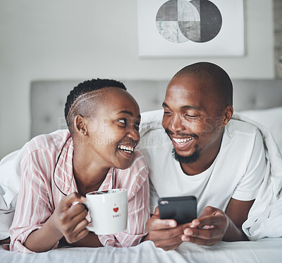 Buy stock photo Black couple in bed with smartphone, coffee and happiness with morning routine, social media or streaming online. Wifi, communication and technology with happy man and woman, relax at home together
