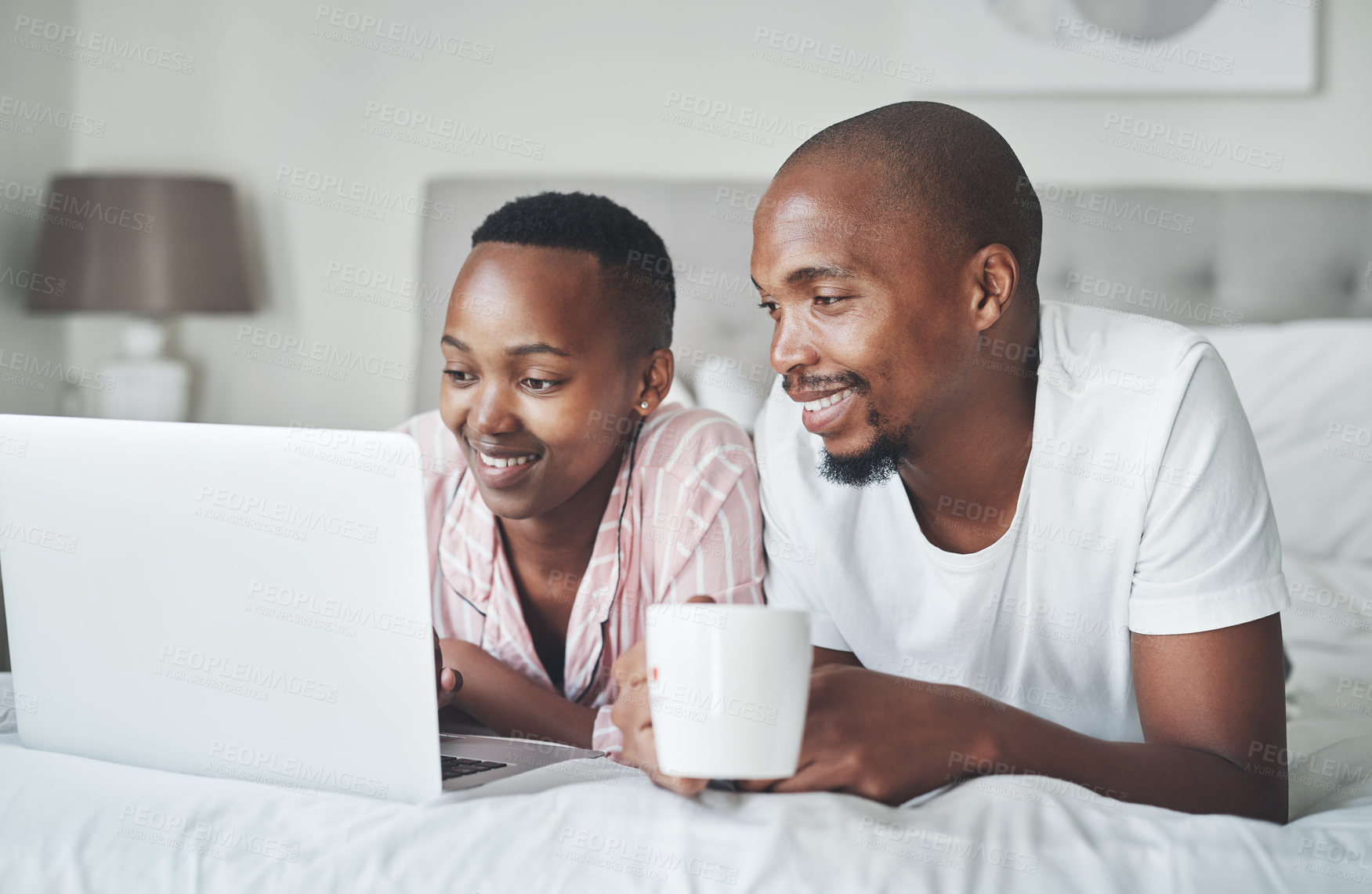 Buy stock photo Love, laptop and black couple in bed with coffee to watch movie on valentines day date in home. Movies, streaming and romance for man and woman in bedroom, happy smile with tech and internet service.