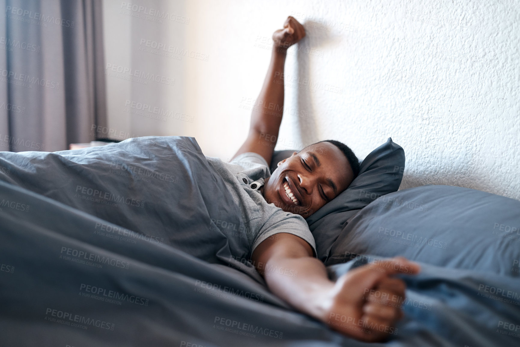 Buy stock photo Wake up, stretching and black man on bed in morning for relaxing, resting and sleeping in bedroom. Apartment, happy and person with smile, blanket and comfortable for health, peace and calm for nap