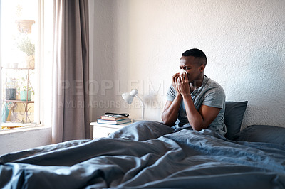 Buy stock photo Blowing nose, man and sick with allergies in bedroom, sneezing and bacteria infection at home. Bed, male person and sinus with tissue for flu virus, fever and disease on weekend in apartment