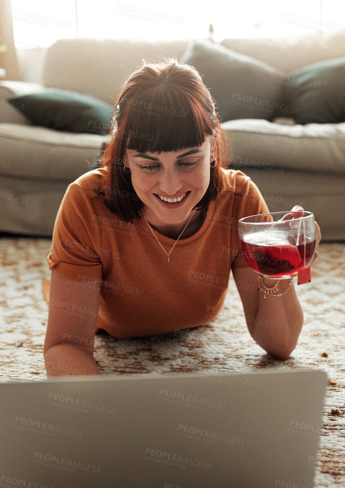 Buy stock photo Tea cup, woman and laptop on floor for reading, ebook and internet for relax in lounge. Warm drink, technology and happy female person in home for website, social media or online for blog and news