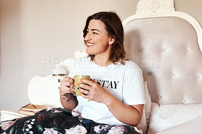 Buy stock photo Shot of a beautiful young woman having coffee in bed