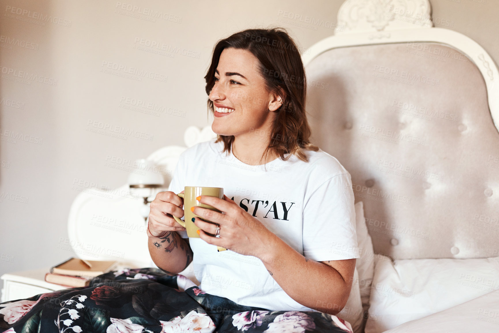 Buy stock photo Shot of a beautiful young woman having coffee in bed
