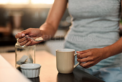 Buy stock photo Cropped shot of a woman making a cup of coffee at home