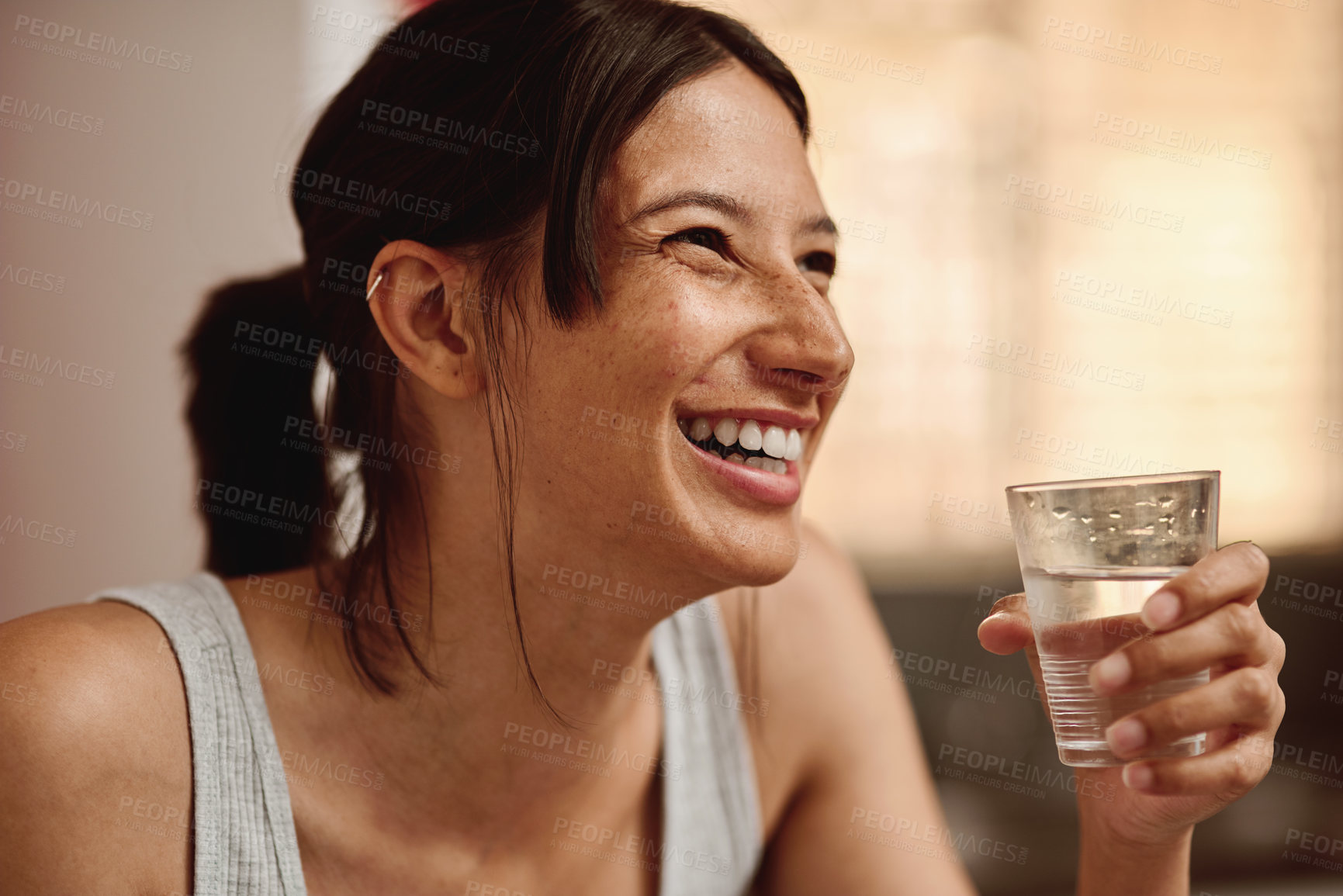 Buy stock photo Shot of a happy young woman having a glass of water in the morning at home