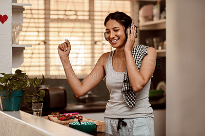 Buy stock photo Music headphones, dancing and woman cooking with fruit, strawberry and food. Dance, headphone and female person making breakfast while listening to audio, sound and radio podcast in happy kitchen.