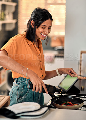 Buy stock photo Shot of a happy young woman preparing a healthy meal at home