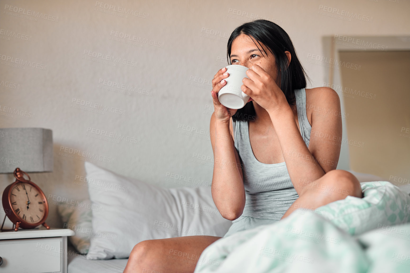 Buy stock photo Young woman, drinking coffee and peaceful morning in bed for wake up, weekend break and stress relief. Female person, hot beverage or caffeine in cup with aroma for energy, wellness and self care