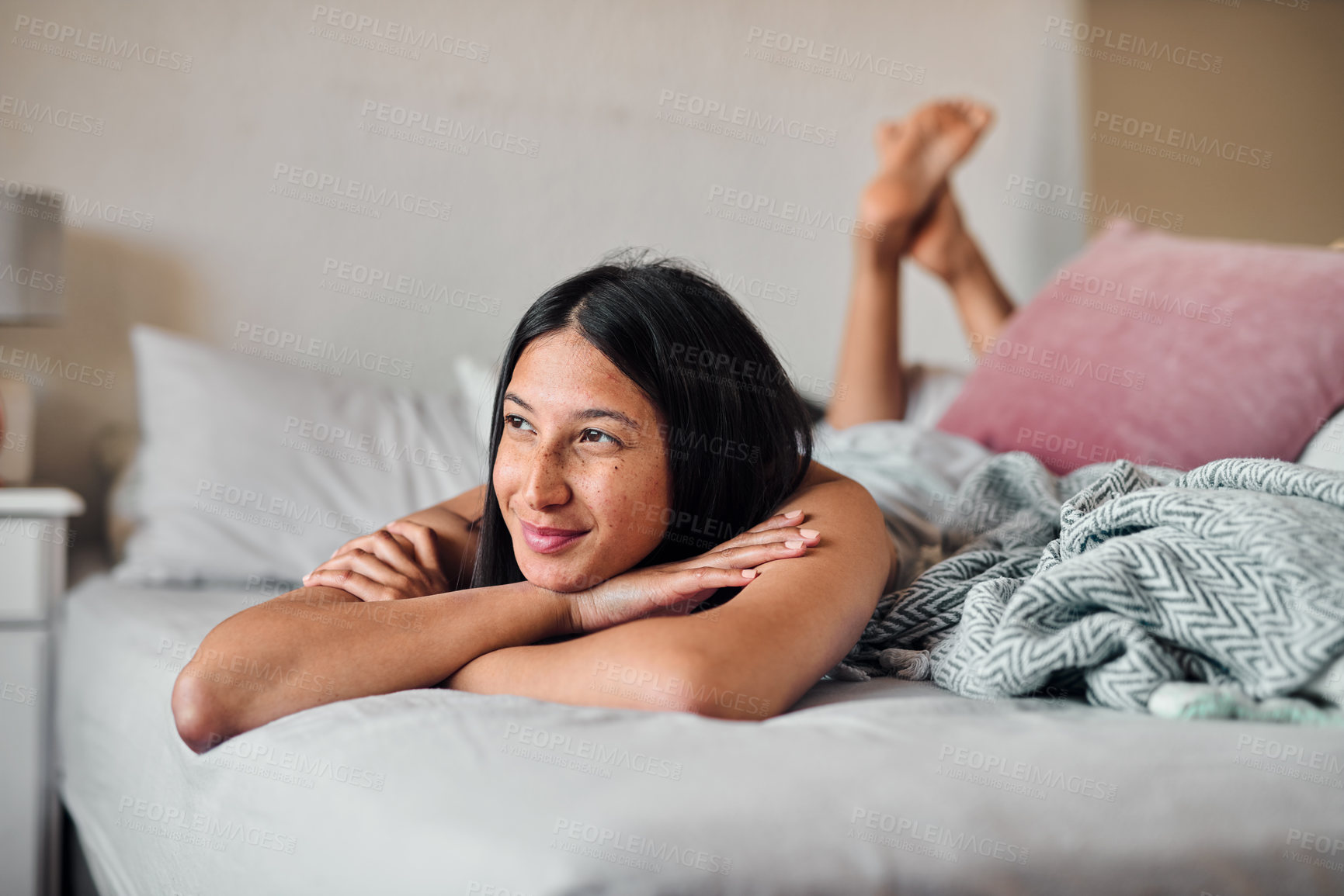 Buy stock photo Shot of a young woman enjoying a relaxing moment in bed at home