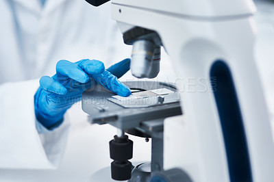 Buy stock photo Hand, microscope and scientist in laboratory for research, experiment or pharmaceutical study. Science, innovation and closeup of medical researcher working with biotechnology equipment for discovery