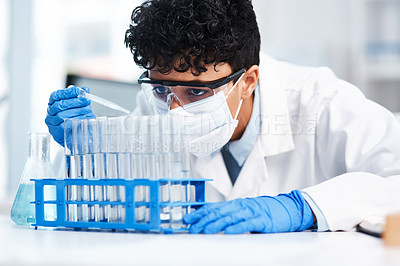 Buy stock photo Shot of a young scientist using a dropper while working with samples in a lab