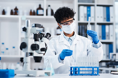 Buy stock photo Shot of a young scientist working with samples in a lab