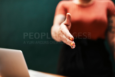Buy stock photo Cropped shot of an unrecognizable businesswoman standing alone and holding out her hand for a handshake