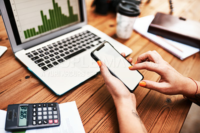 Buy stock photo Cropped shot of an unrecognizable businesswoman sitting alone at her desk and texting on her cellphone