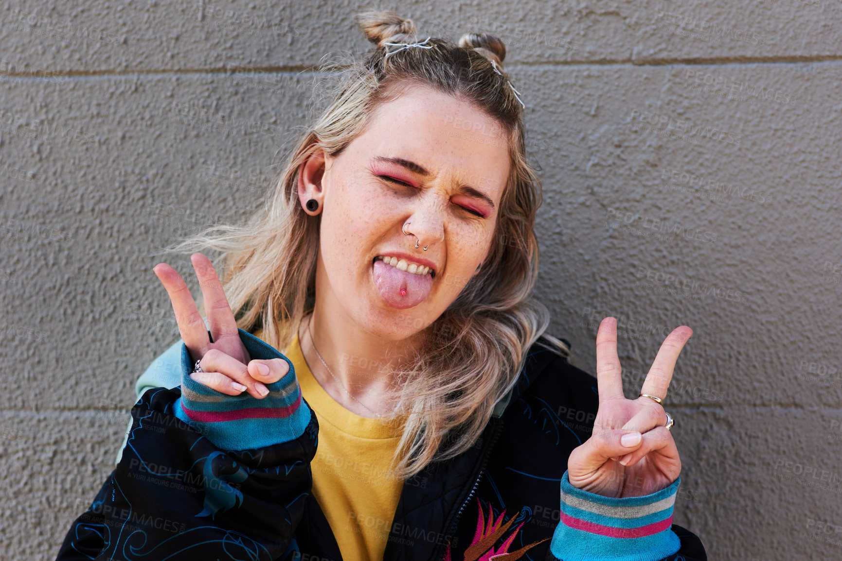 Buy stock photo Smile, woman tongue and outdoor peace sign with y2k fashion and silly expression by wall background. Gen z girl, happy and v emoji for hand with street style confidence and comedy face for piercing