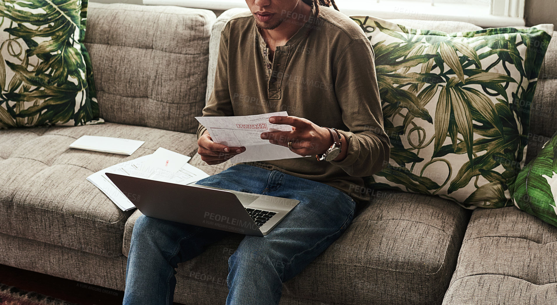 Buy stock photo Paperwork, laptop and man sitting on sofa in home for finance, accounting and debt in living room. Computer, documents and online for insurance, bills and overdue payment with budget in apartment