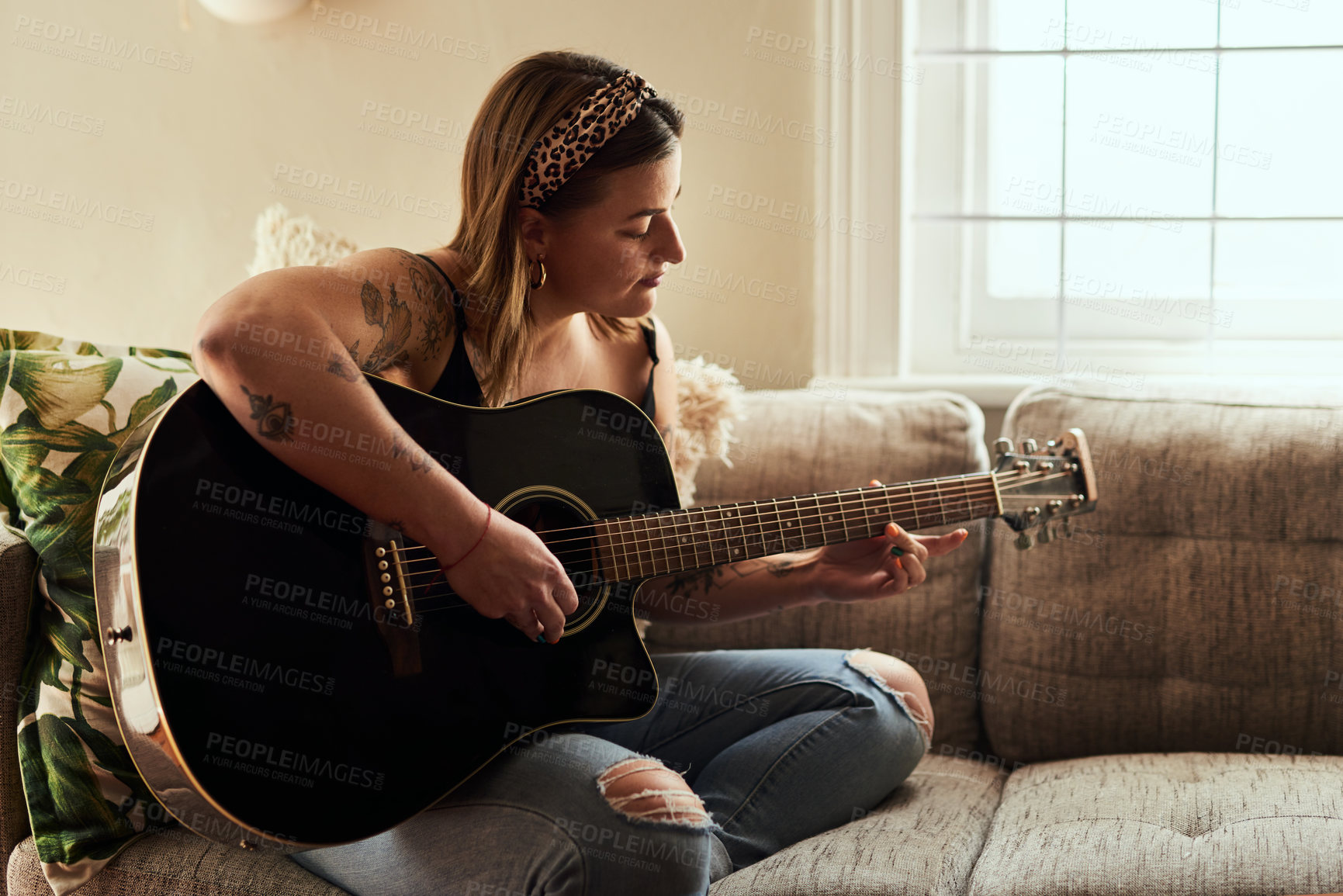 Buy stock photo Woman, relax and guitar on sofa for music, practice and learning chords in home. Musician, string instrument and strumming in living room with talent, pitch development or rehearsal for performance