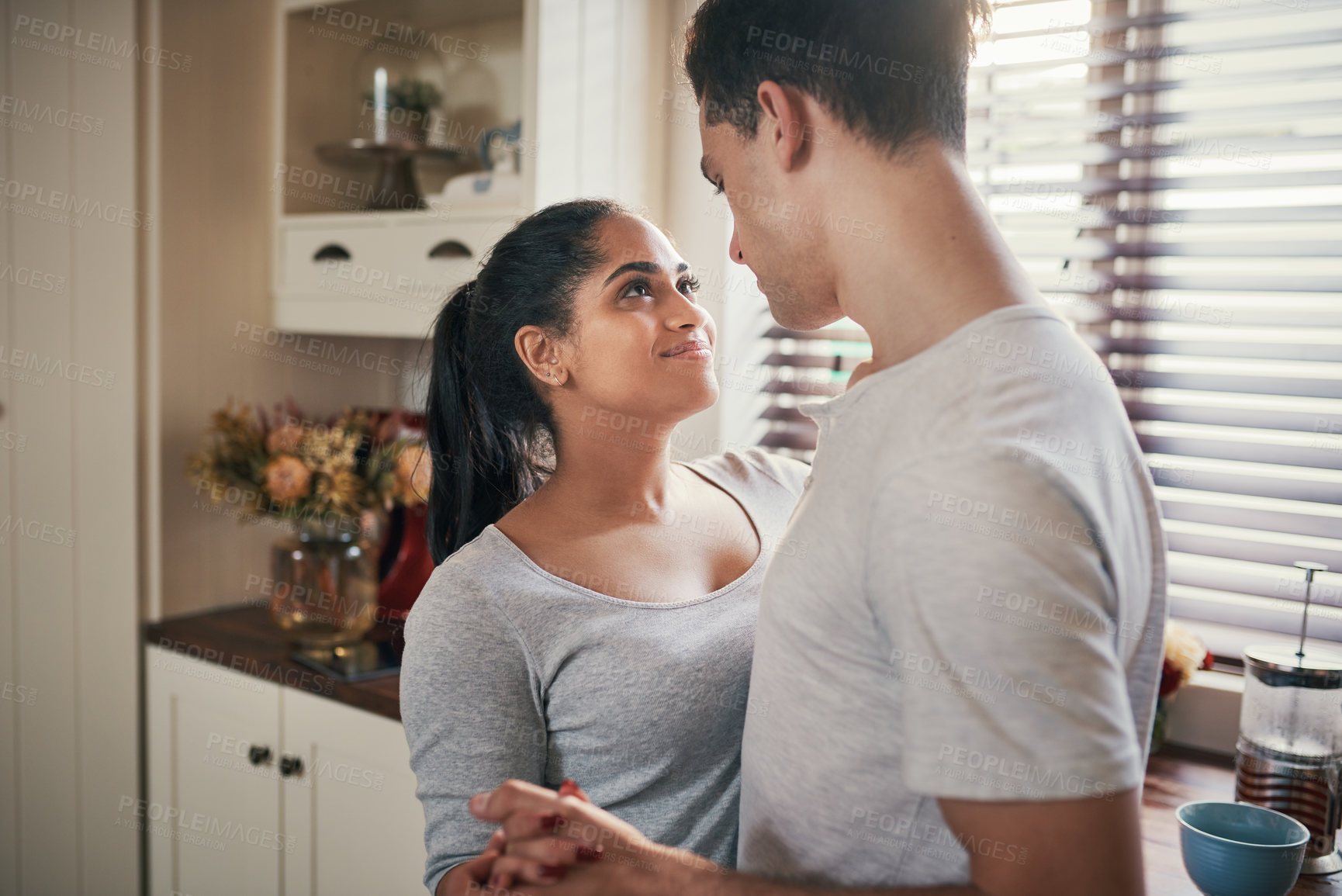 Buy stock photo Cropped shot of a happy young couple slow dancing in their kitchen