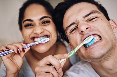 Buy stock photo Cropped shot of a young couple brushing their teeth together