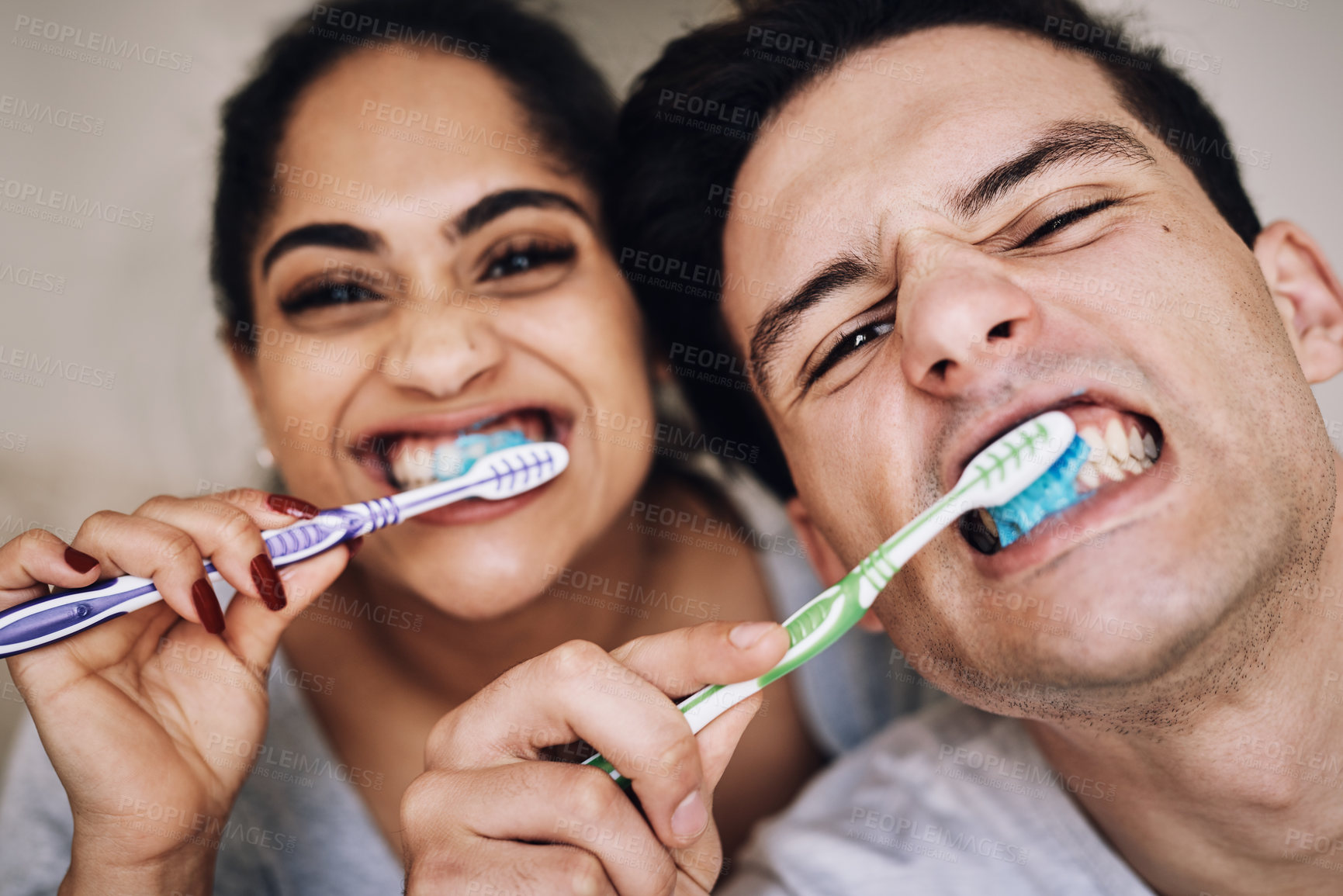 Buy stock photo Cropped shot of a young couple brushing their teeth together