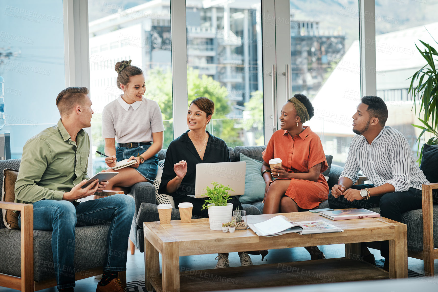 Buy stock photo Cropped shot of a diverse group of businesspeople sitting in the office together and having a meeting