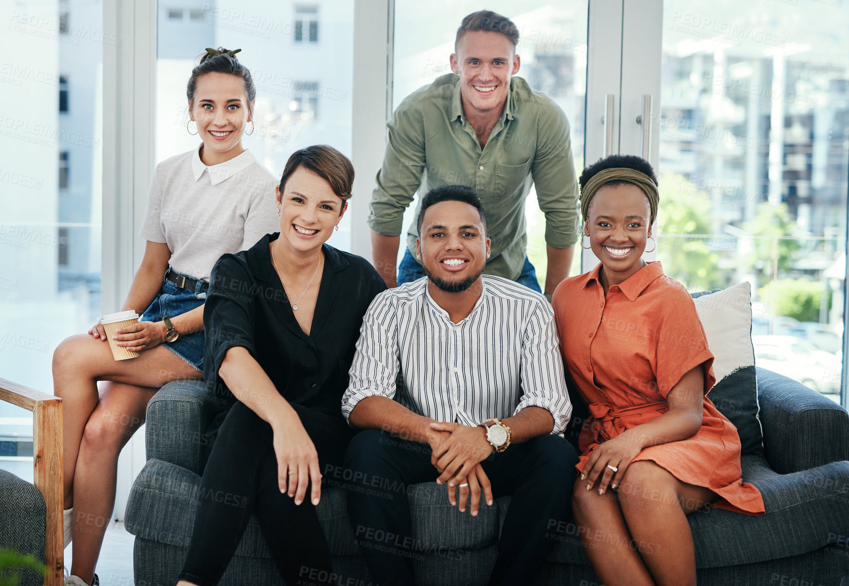 Buy stock photo Cropped portrait of a diverse group of business colleagues sitting together in the office