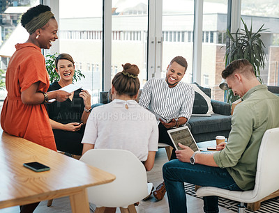 Buy stock photo Cropped shot of a diverse group of businesspeople sitting in the office together and bonding