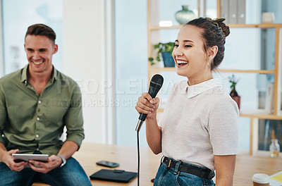 Buy stock photo Cropped shot of an attractive young businesswoman using a mic to deliver her speech to her colleagues in the office