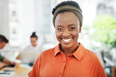 Buy stock photo Cropped portrait of an attractive young businesswoman standing alone in the office and smiling at the camera