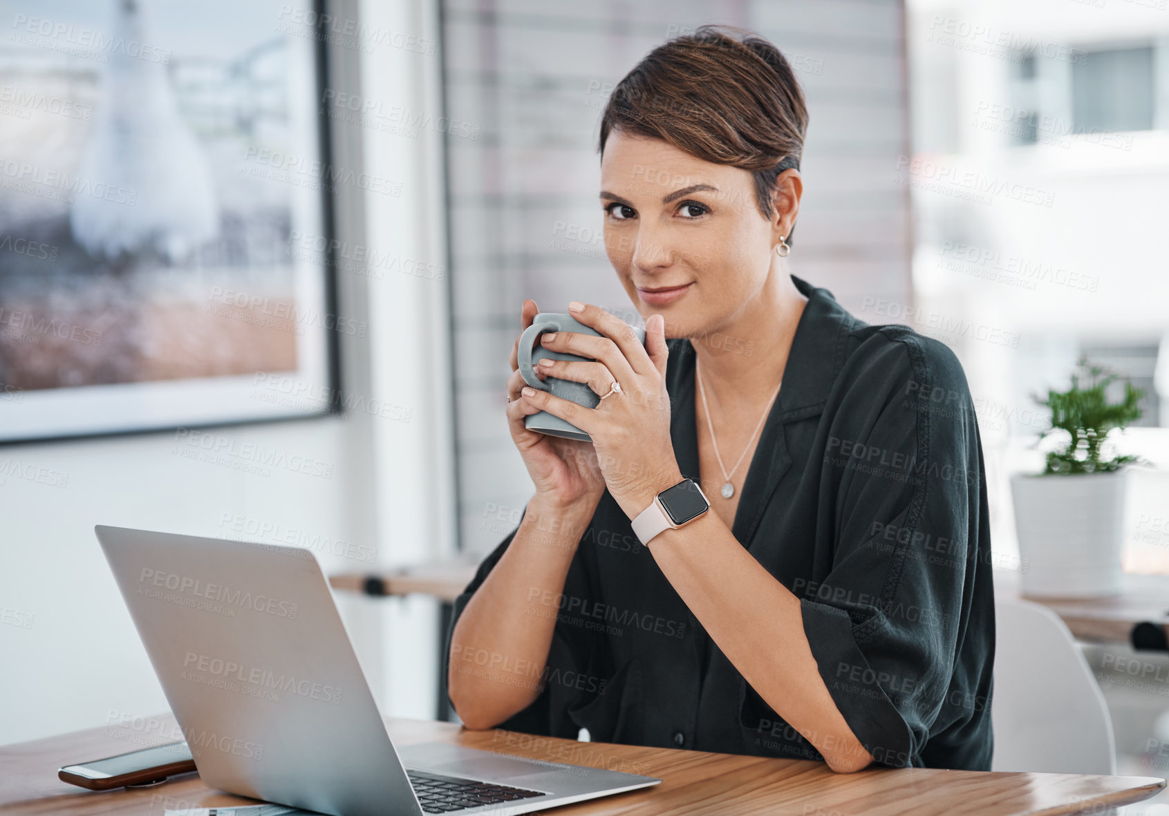 Buy stock photo Cropped portrait of an attractive young businesswoman sitting alone and enjoying a cup of coffee in her office