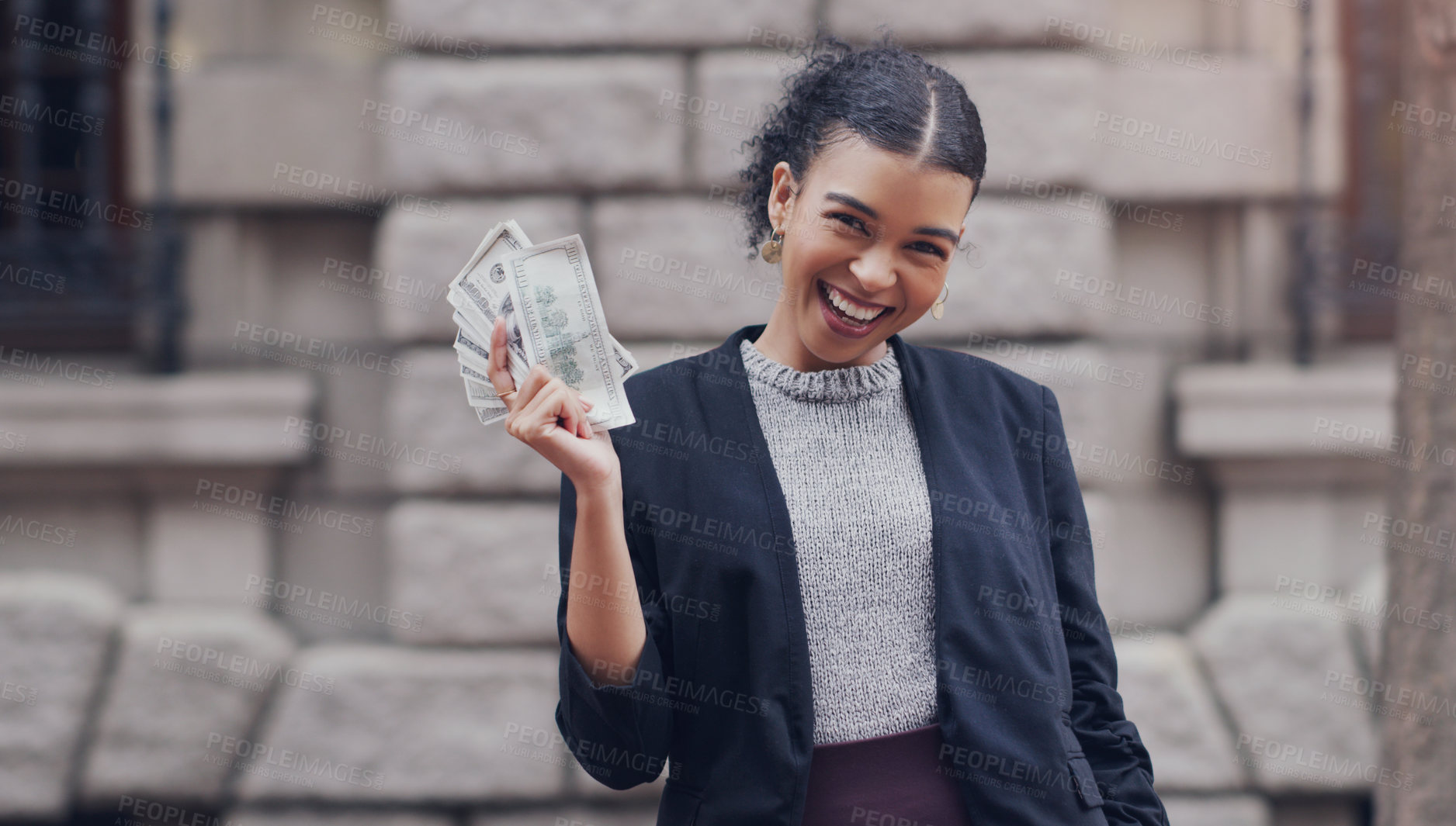 Buy stock photo Cropped portrait of an attractive young businesswoman smiling while holding a stack of money while standing outdoors in the city