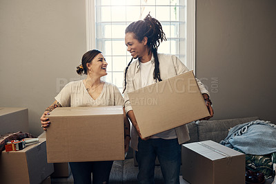 Buy stock photo Shot of a happy young couple moving into their new home