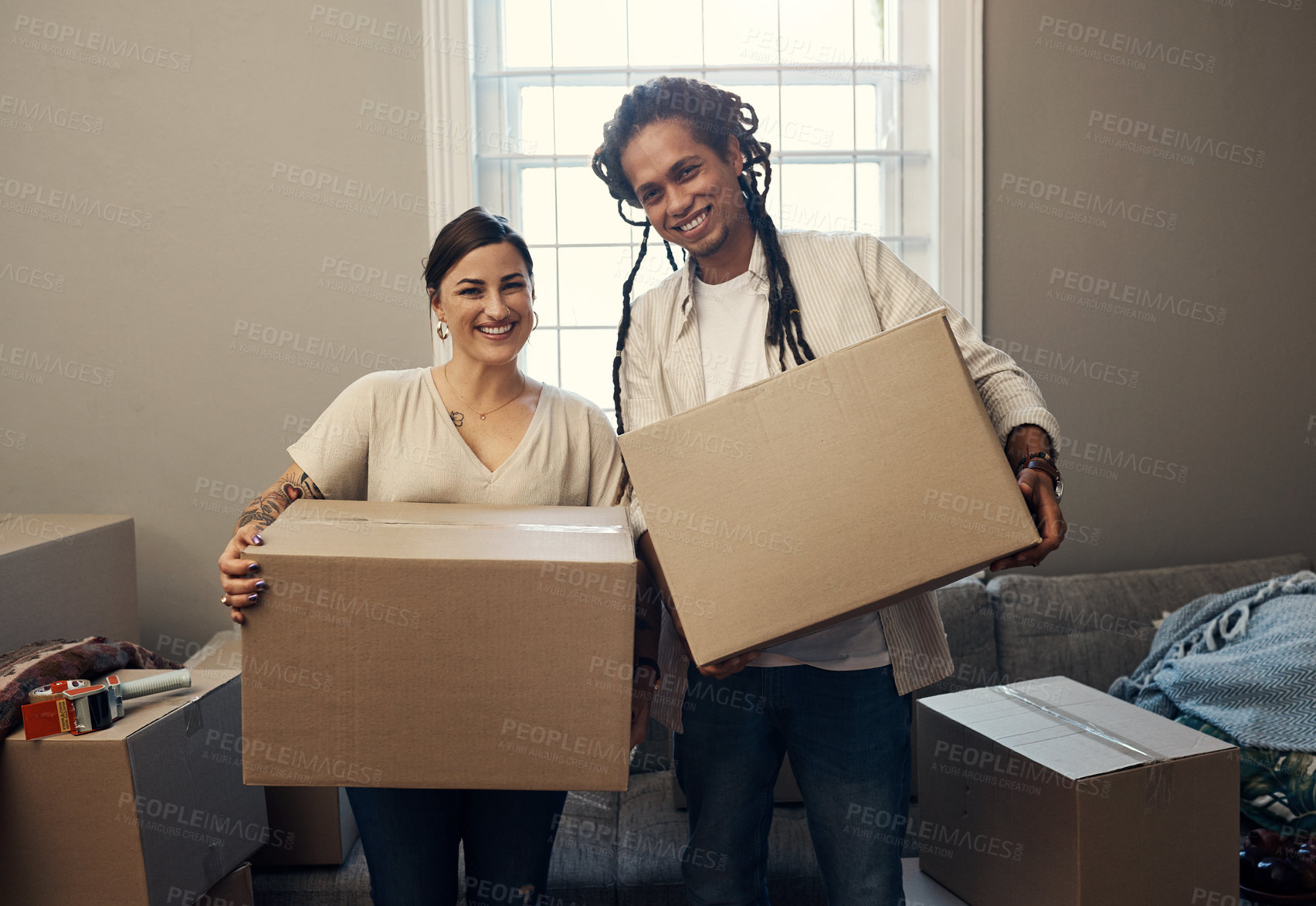 Buy stock photo Boxes, portrait and interracial couple in living room for mortgage, real estate or moving. Partners, married man and happy woman with cardboard for homeowner, property or relocation in new apartment