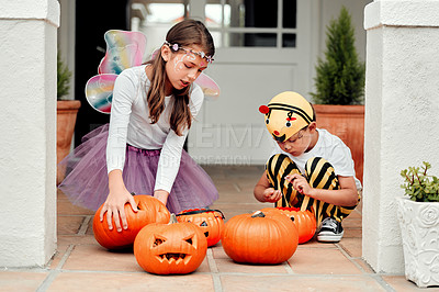 Buy stock photo Shot of two adorable young siblings playing together on Halloween at home
