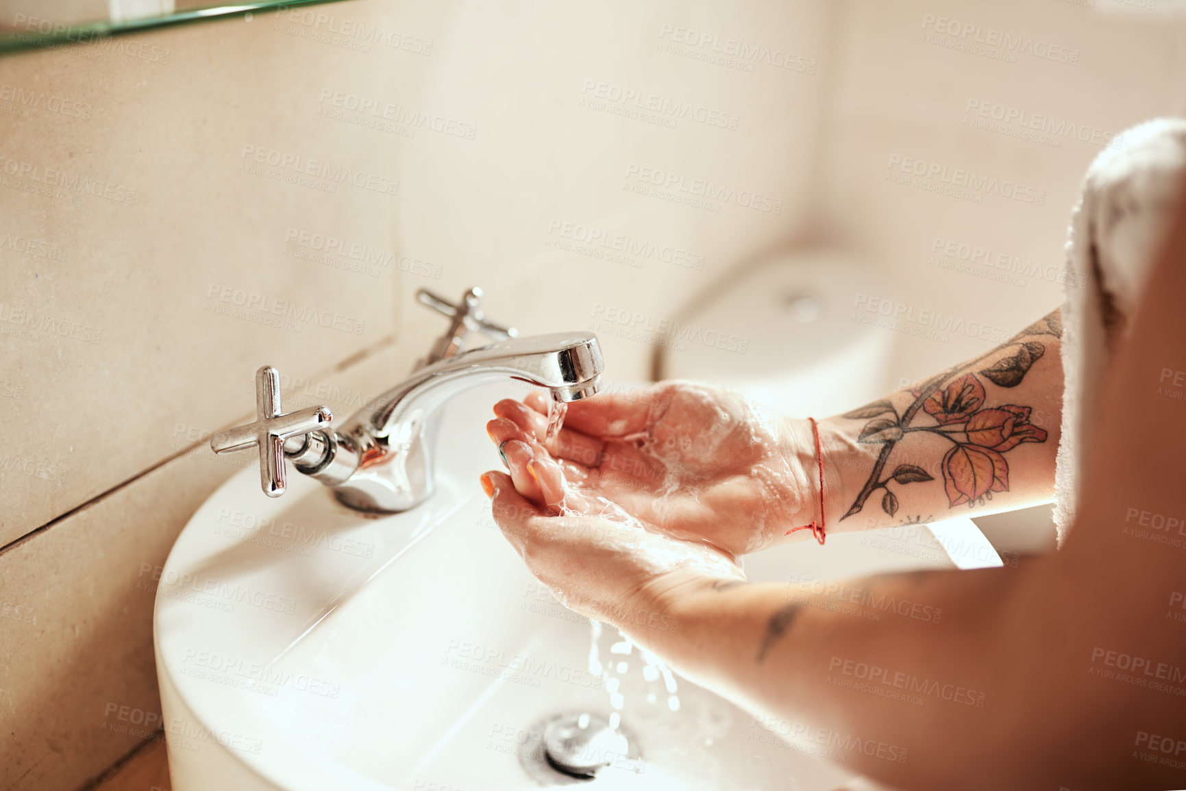 Buy stock photo Cropped shot of a woman washing her hands at the bathroom sink