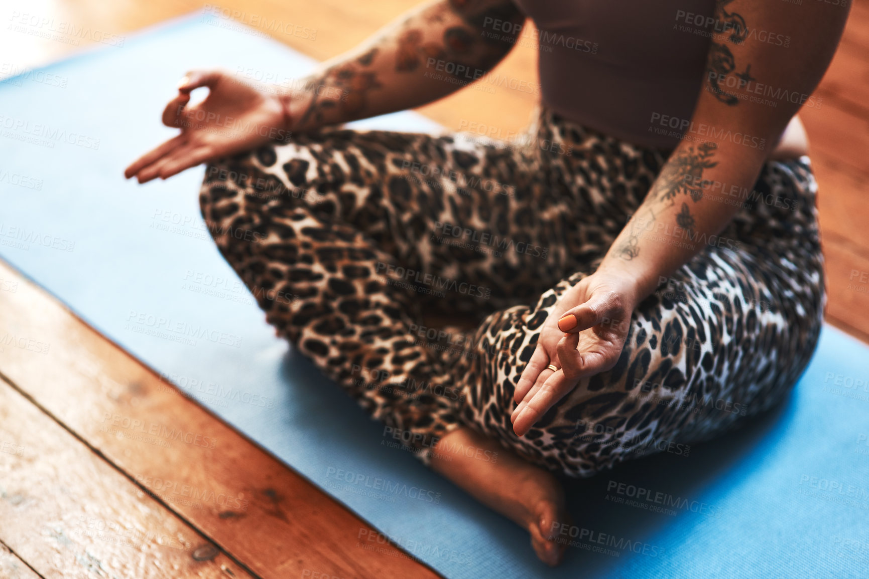 Buy stock photo Closeup shot of a woman meditating on a yoga mat at home