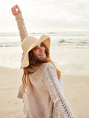 Buy stock photo Portrait of a young woman standing with her arms outstretched at the beach