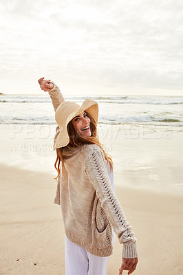 Buy stock photo Portrait of a young woman standing with her arms outstretched at the beach