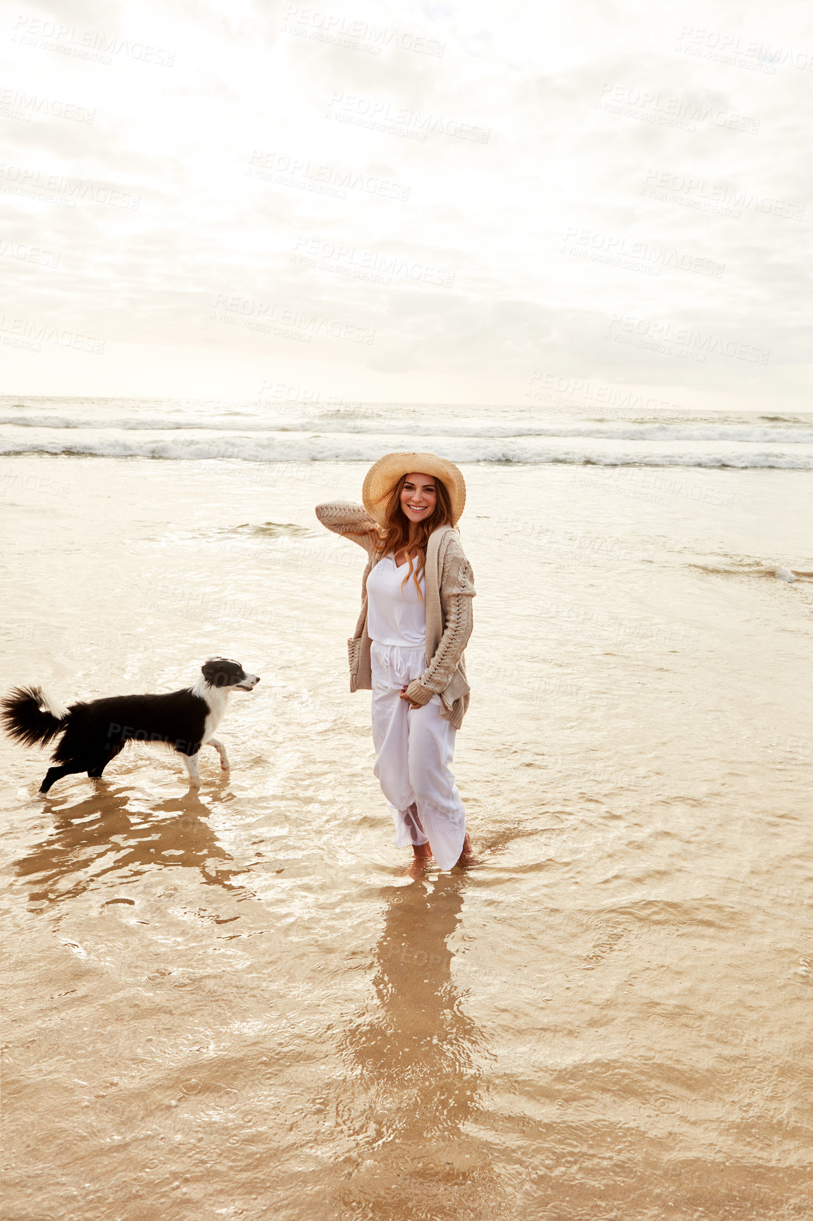 Buy stock photo Portrait of a young woman spending some time with her dog at the beach