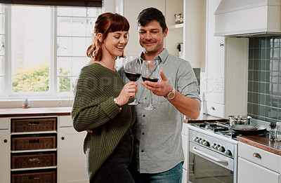 Buy stock photo Cropped shot of an affectionate couple enjoying a glass of wine at home