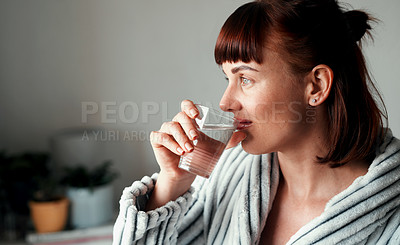 Buy stock photo Cropped shot of an attractive young woman drinking water in her bedroom at home